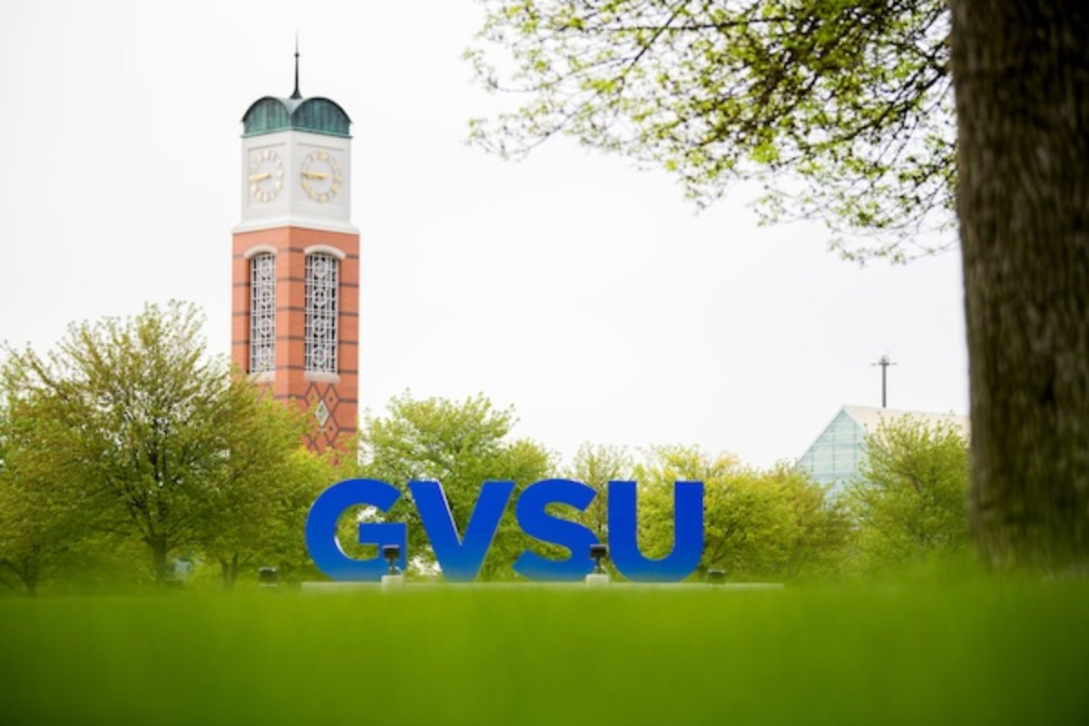 Clocktower and blue GVSU letters in the foreground on the Allendale campus