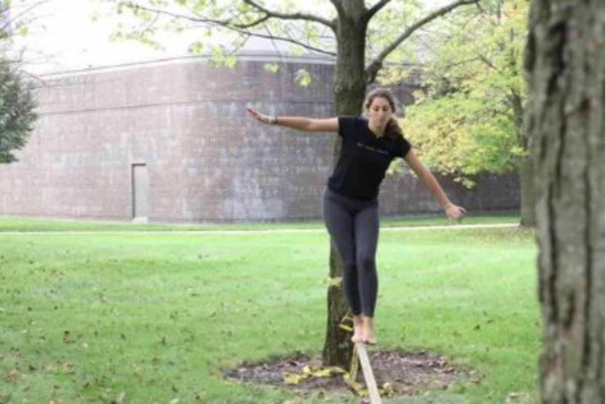 A Student walking on a tight rope