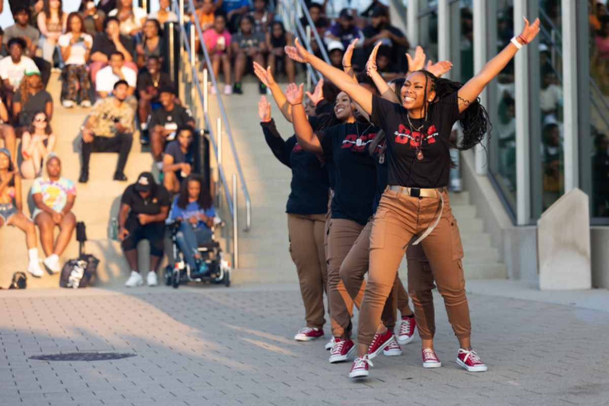 People dancing during the NPHC event and people watching