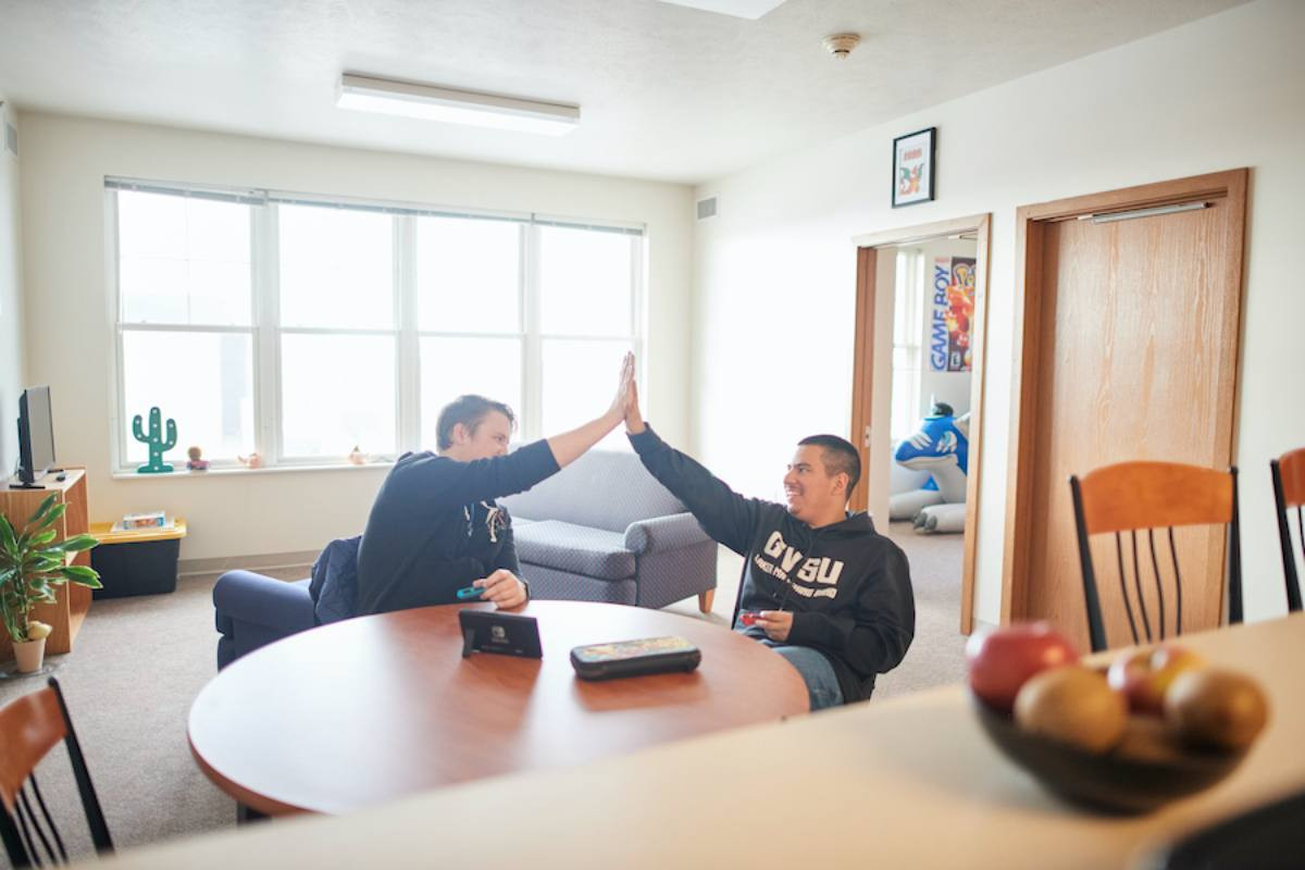 roommates high fiving as they resolved their issue