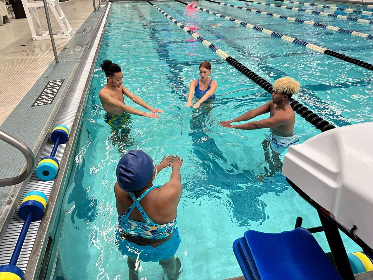 three students taking Adult Swim Lessons with RecWell