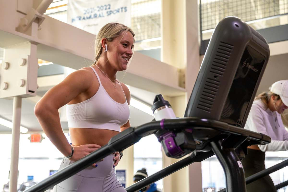 Girl smiling and walking on a stair stepper