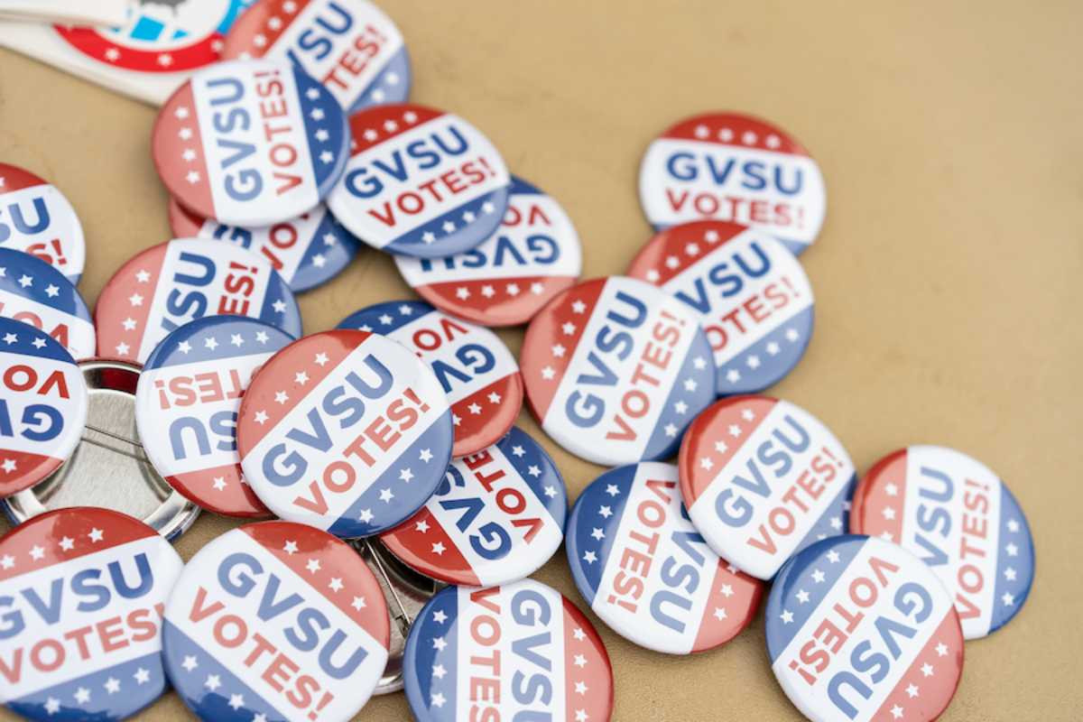 a picture of pins that say GVSU Votes!