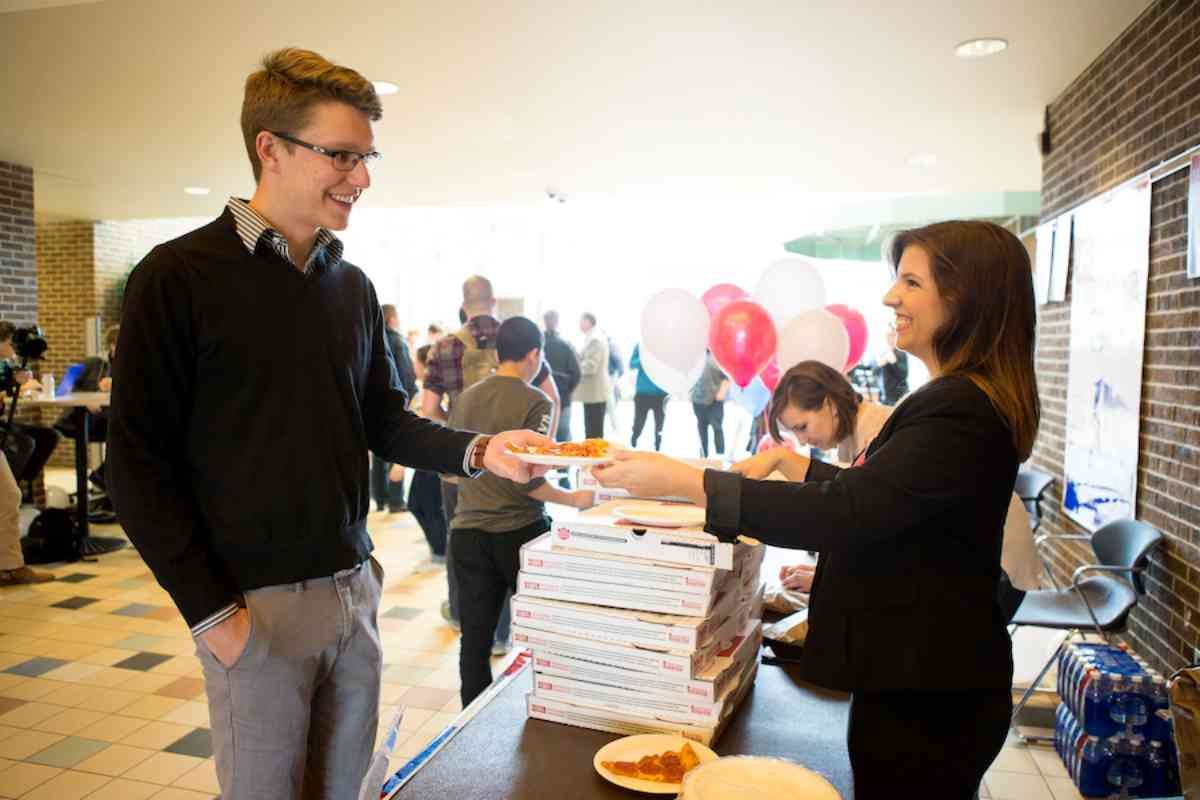 Students receiving free pizza at the Dem 101 event