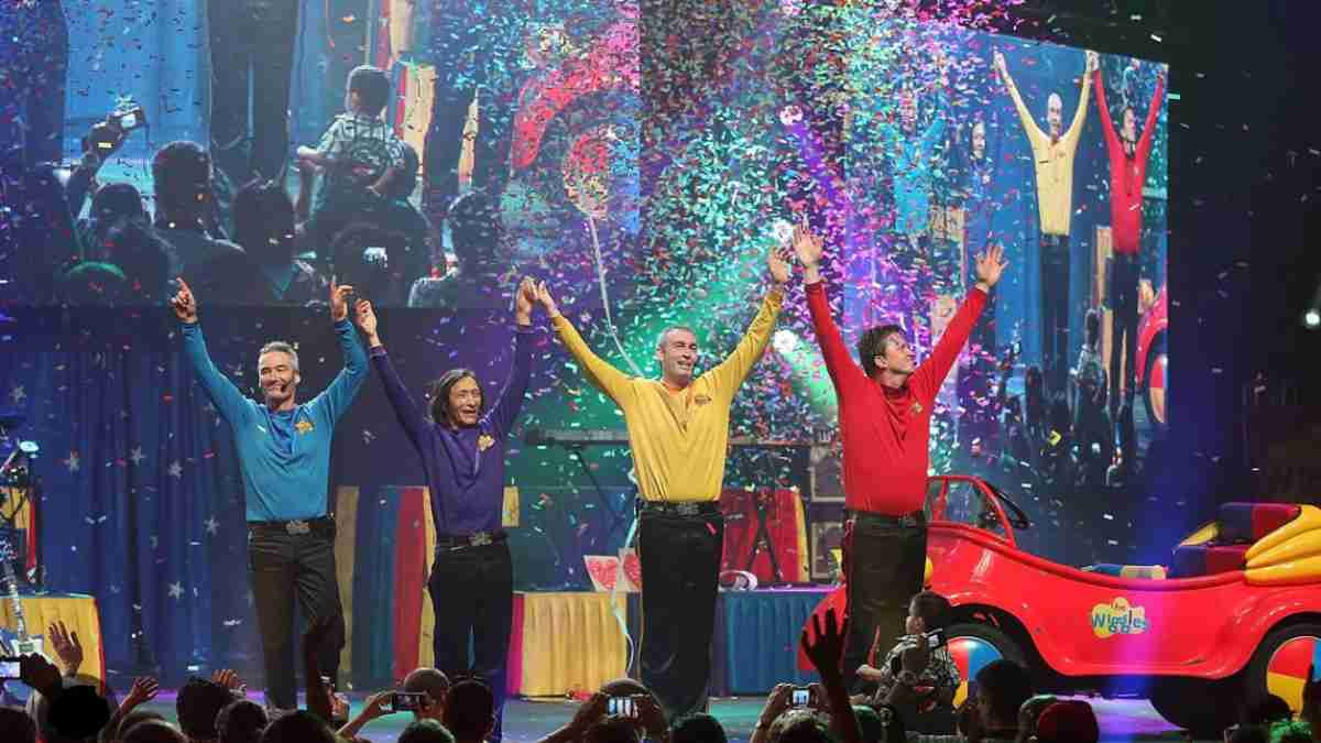 The wiggles standing on stage with confetti falling around them