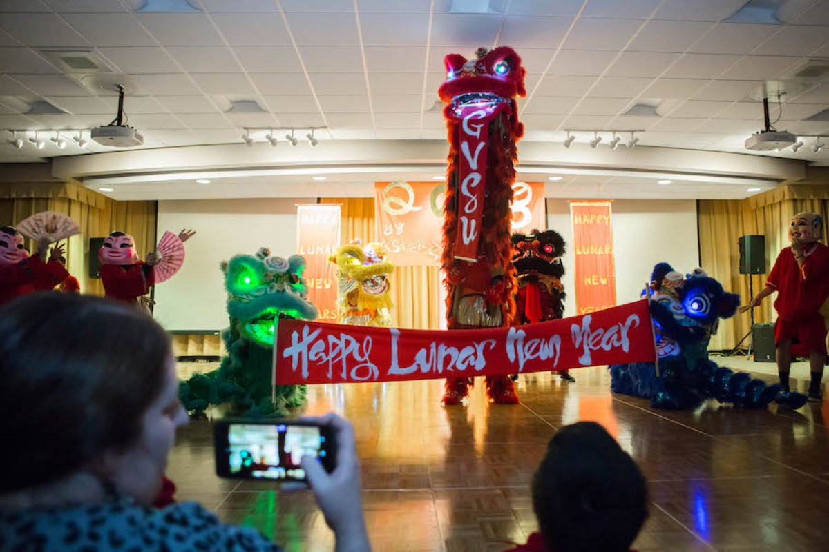 An Asian New Year Festival with a sign that says GVSU Happy Lunar New Year