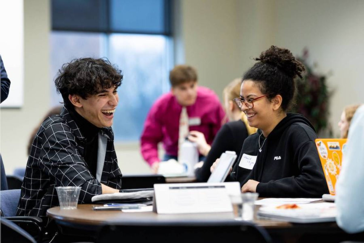 Two students laughing and talking at ElectHer