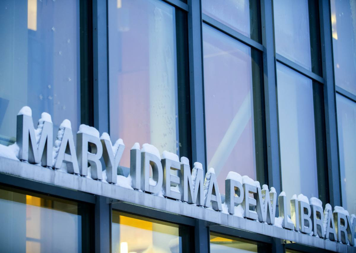 The Mary Idema Pew Library sign covered in snow