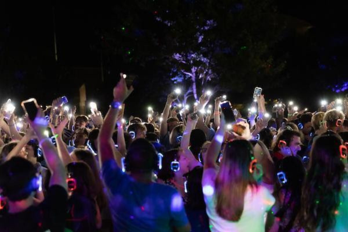 people wearing light up headphones and dancing
