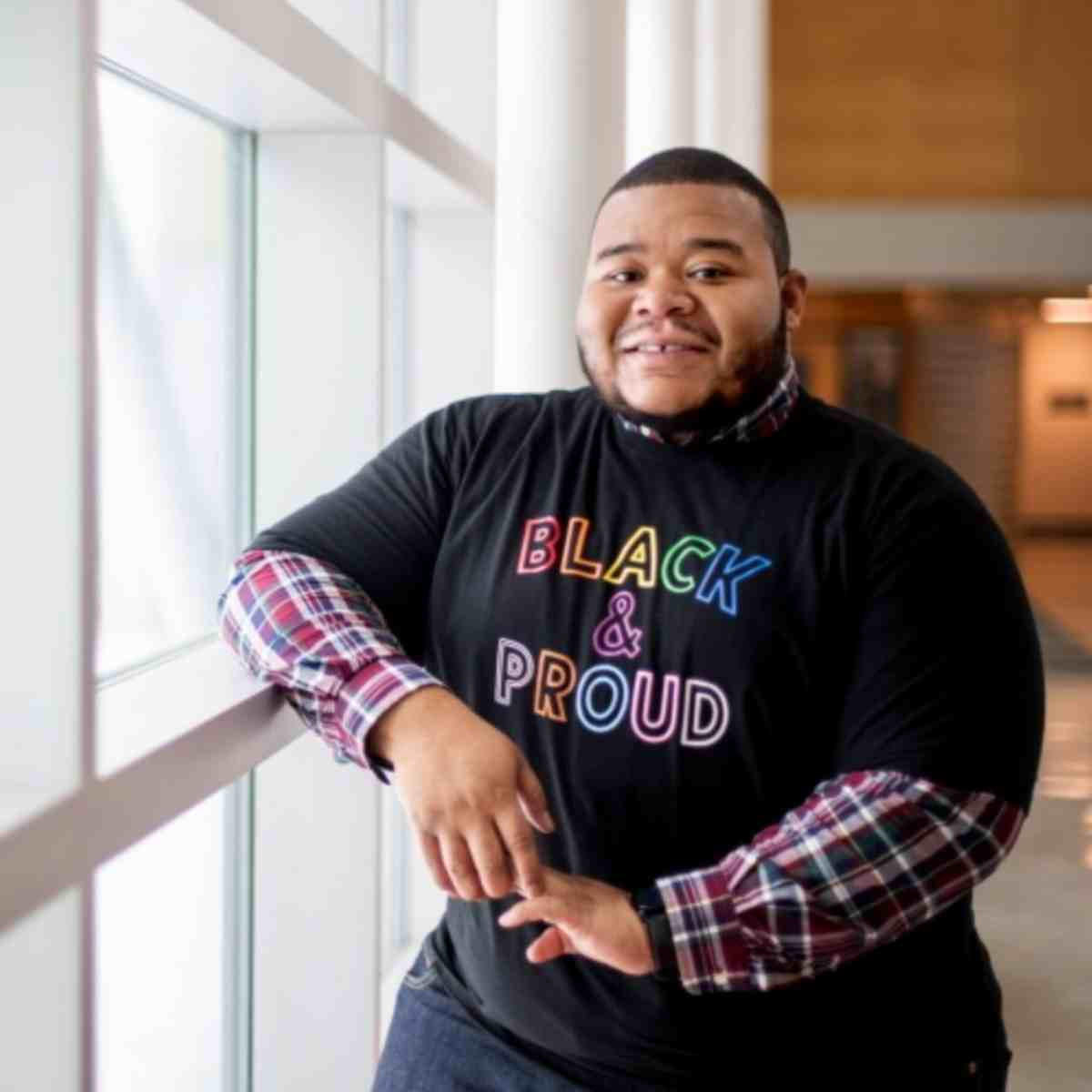Staff with a "Black and Proud" t-shirt on for black history month