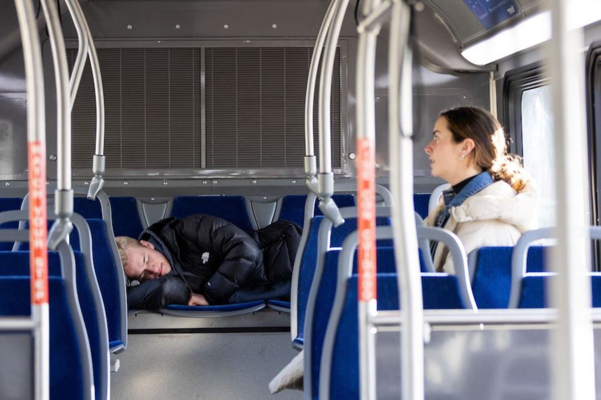 two students sleeping on the bus