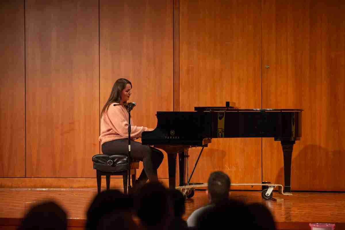 Student singing and playing the piano at GV's Got Talent