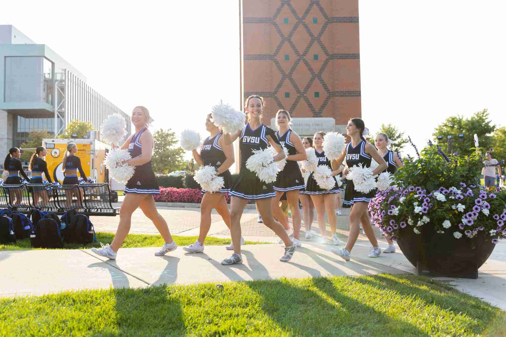 Cheerleaders walking outside by the clock tower