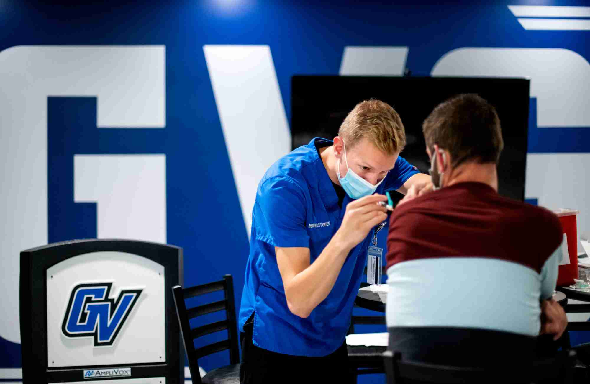 Nurse giving a student a flu shot