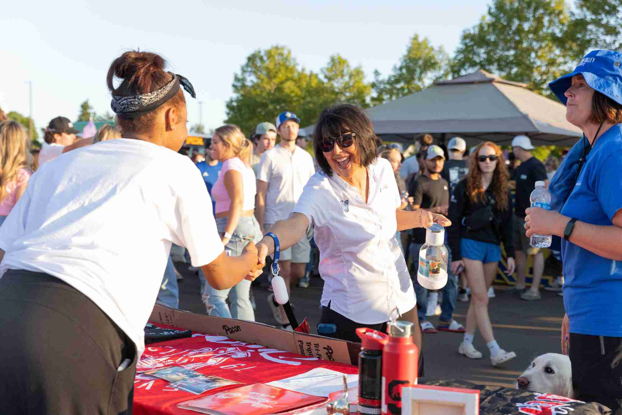 president of gvsu shaking hands with a club member