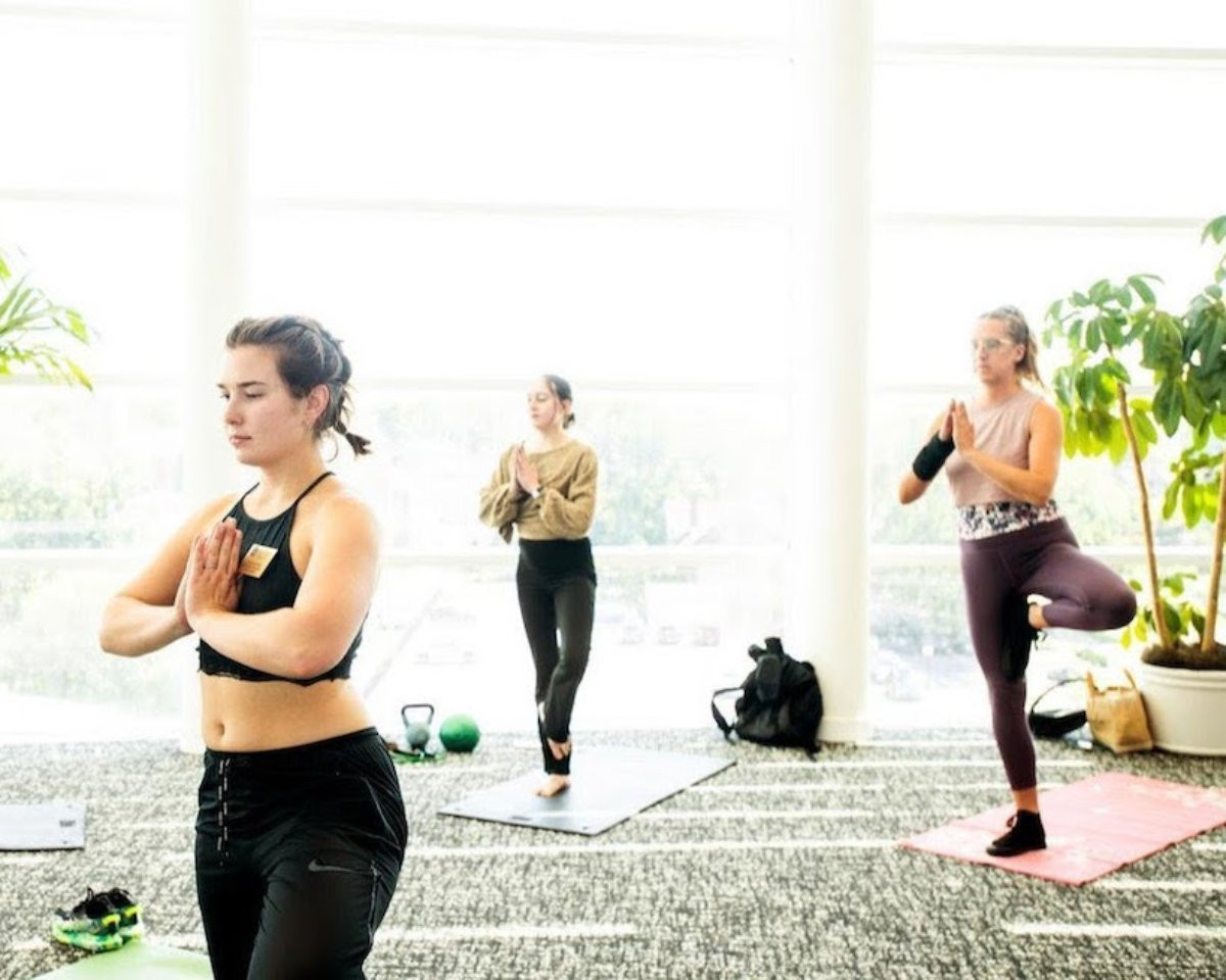 three girls doing yoga for national yoga month