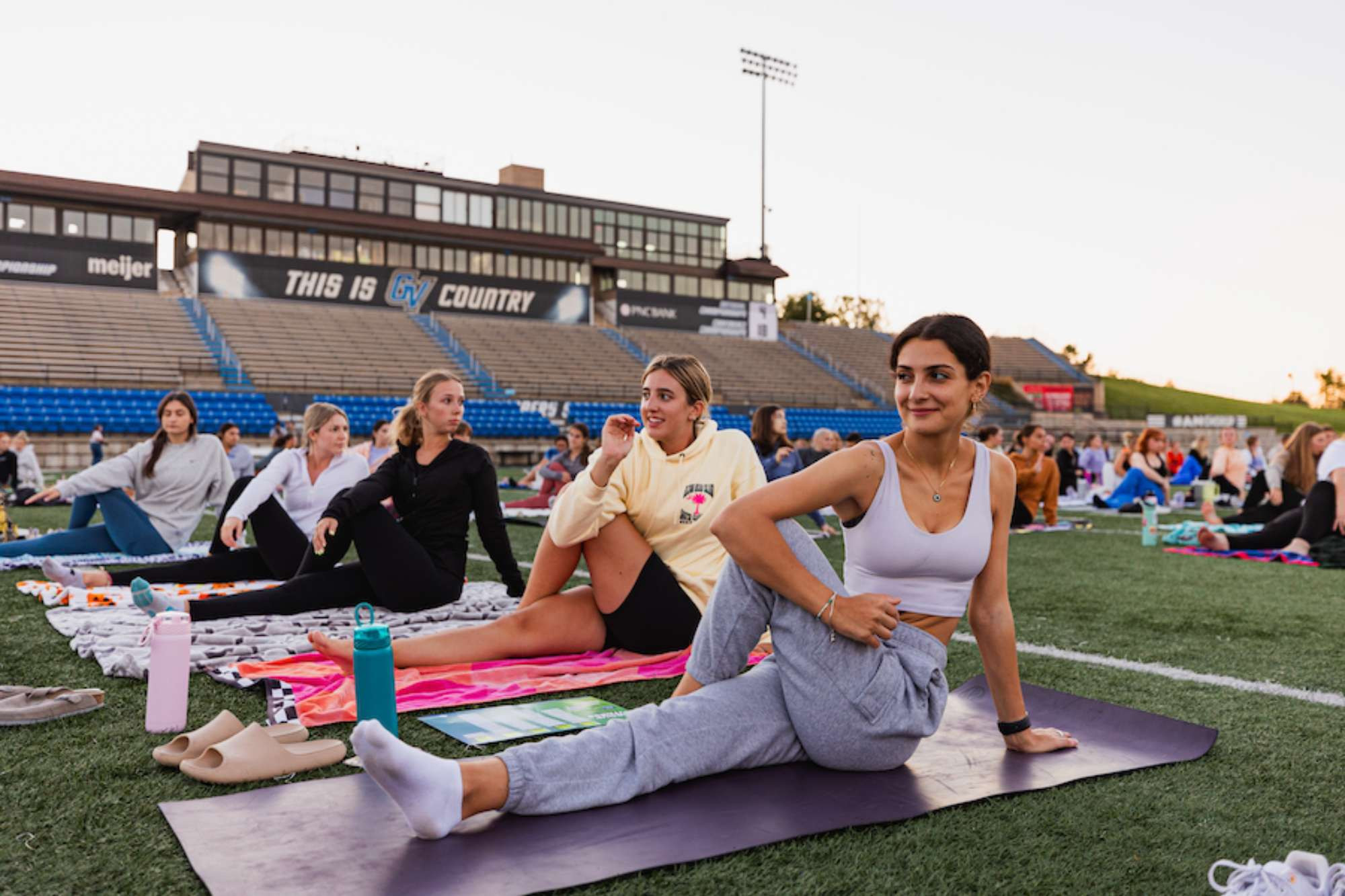 girls doing yoga on lubbers field