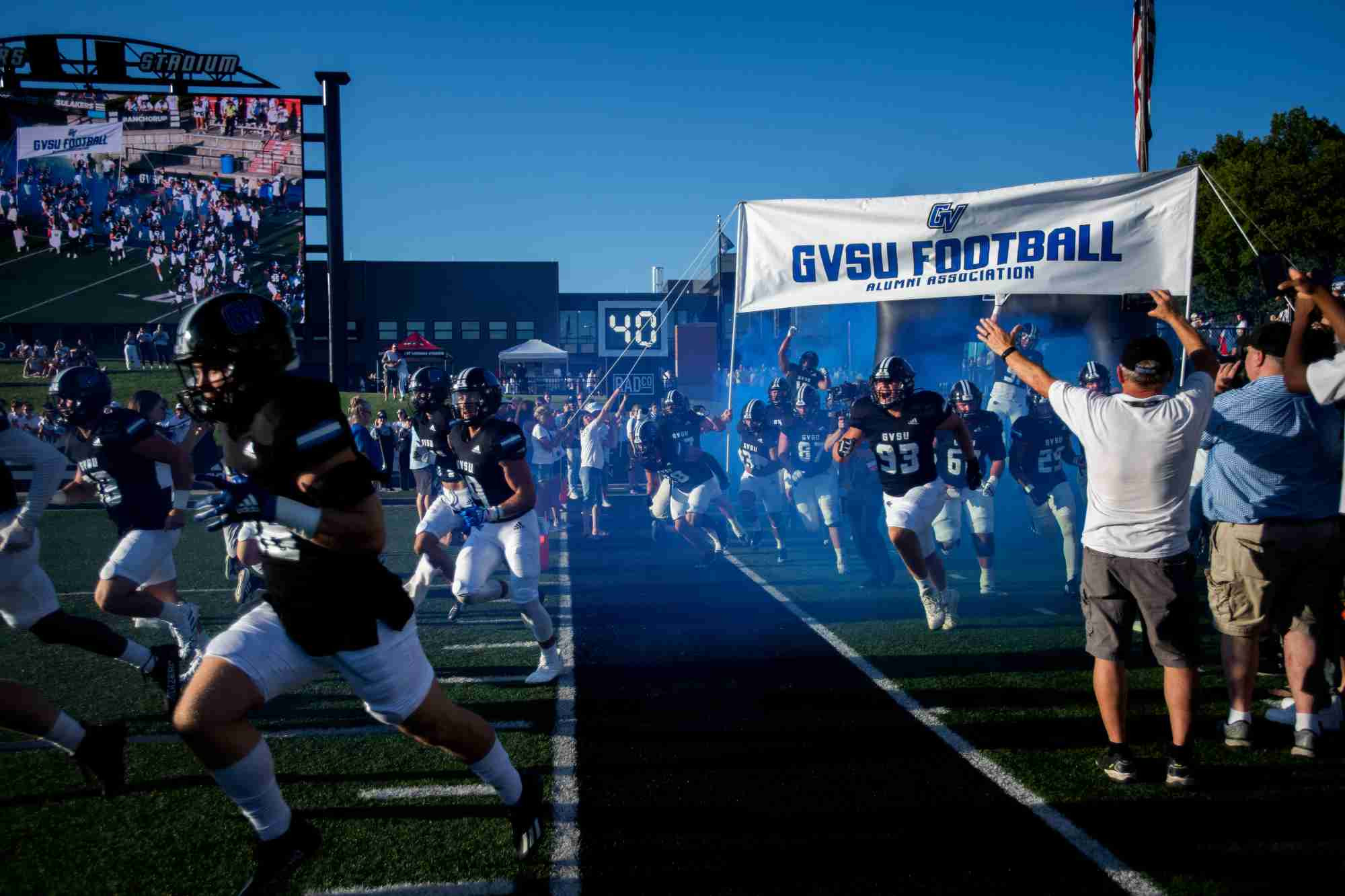 Football players running out on the field