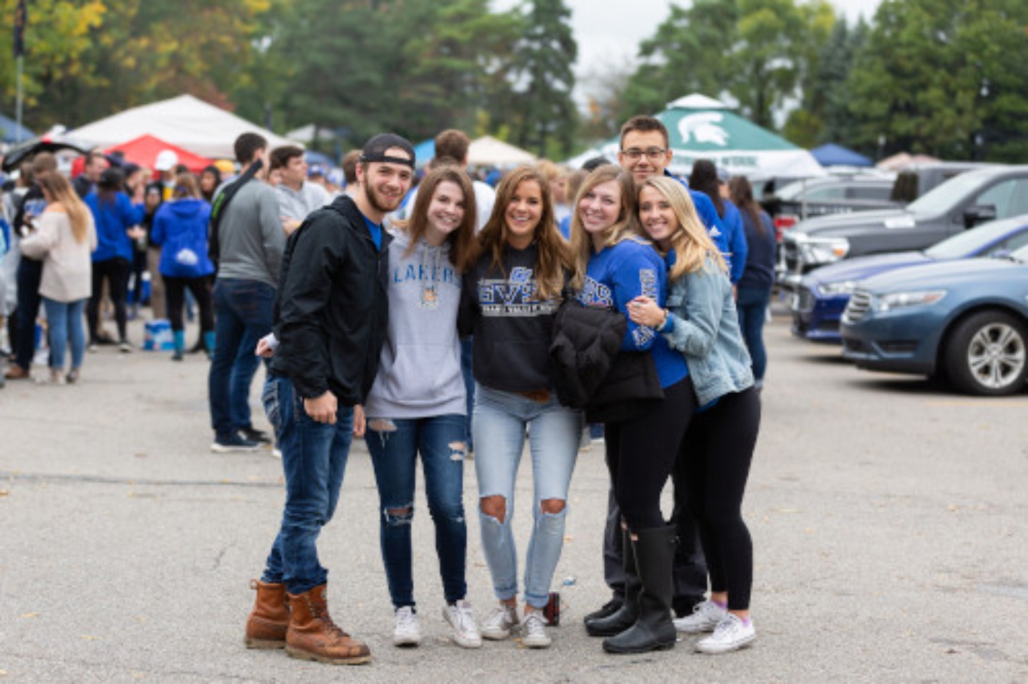 Students takings a picture in the tailgating lot 