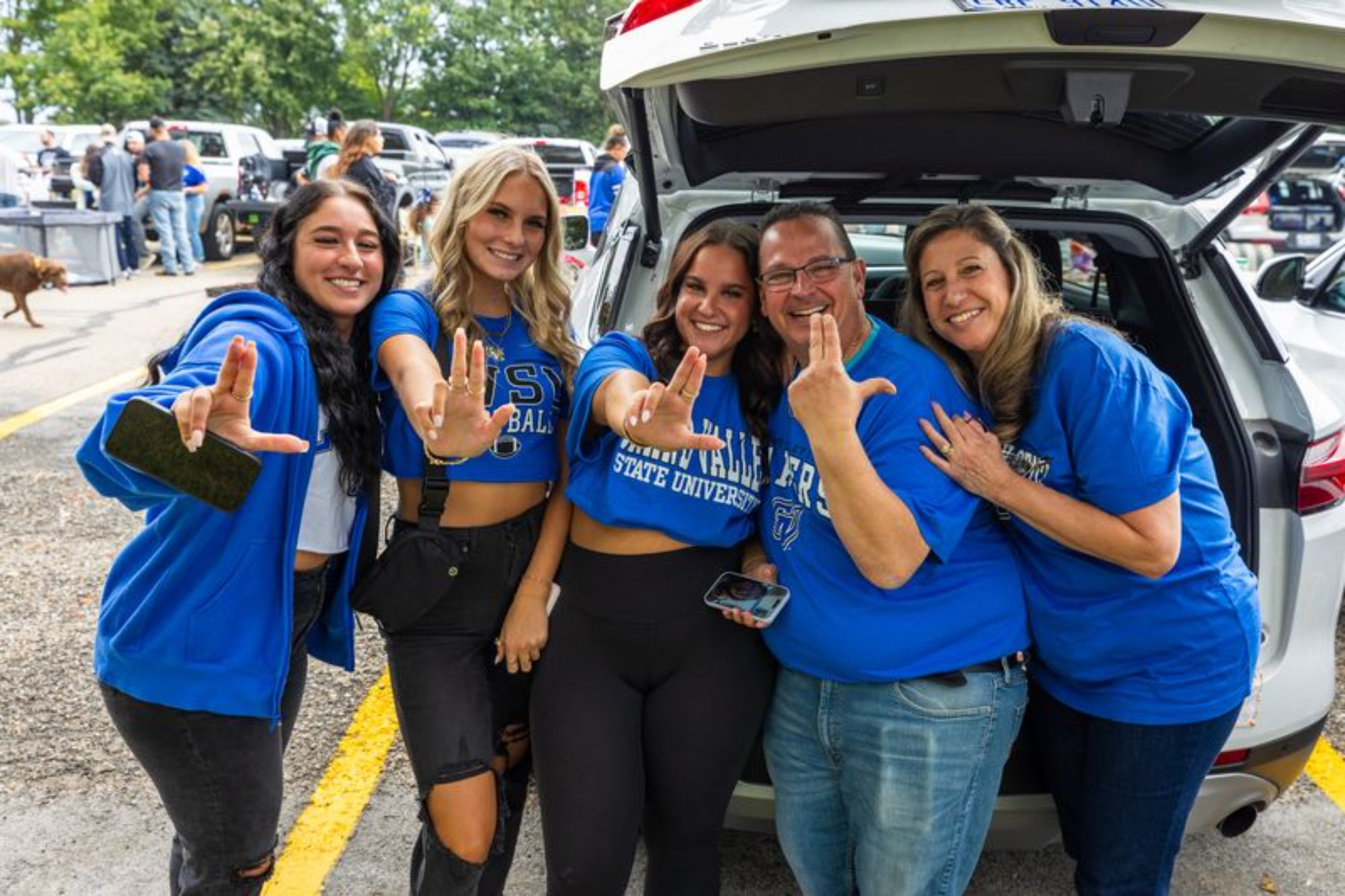 A family tailgating before the football game during the GVSU Family Weekend