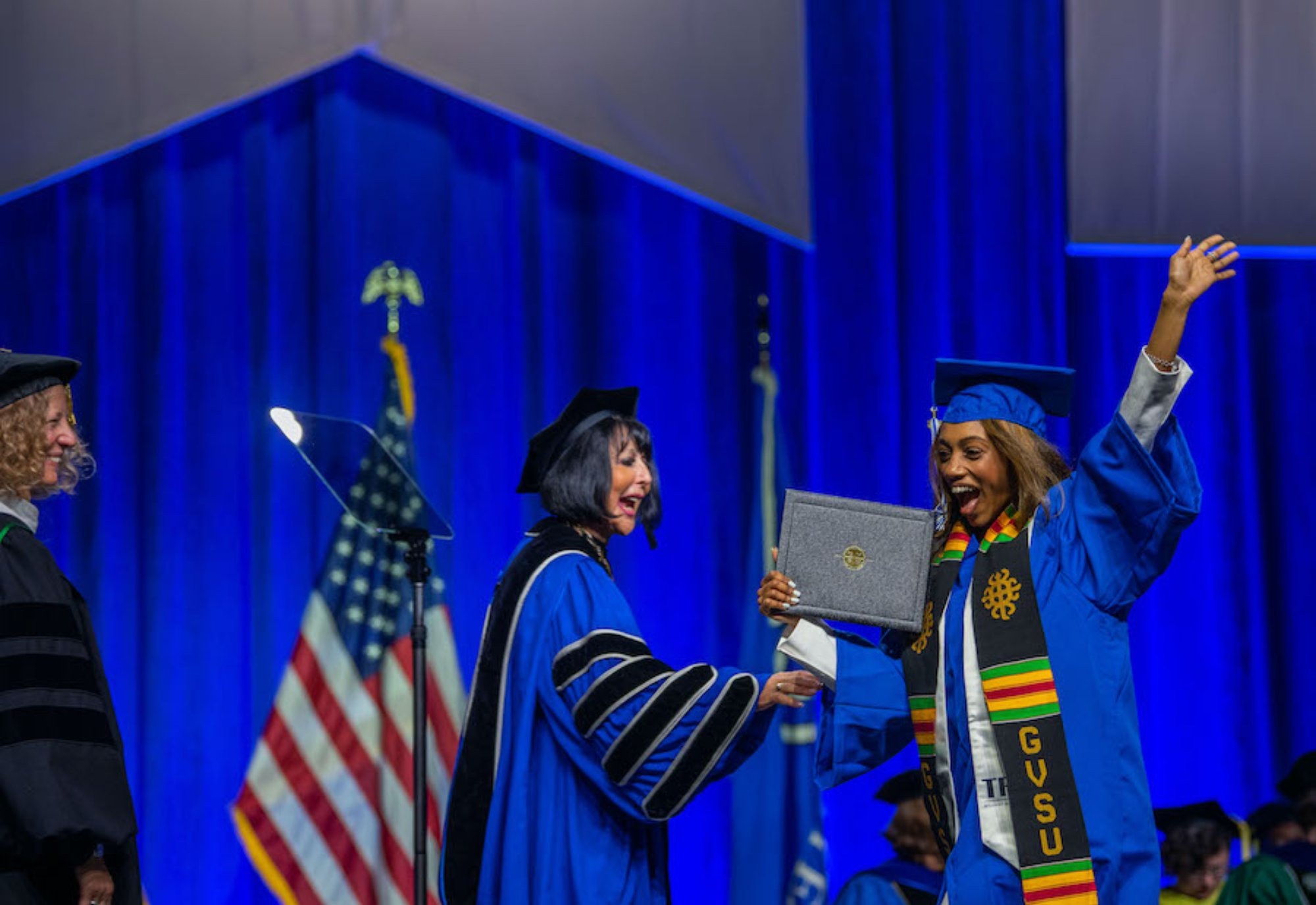 Student accepting her diploma from President Mantella during graduation