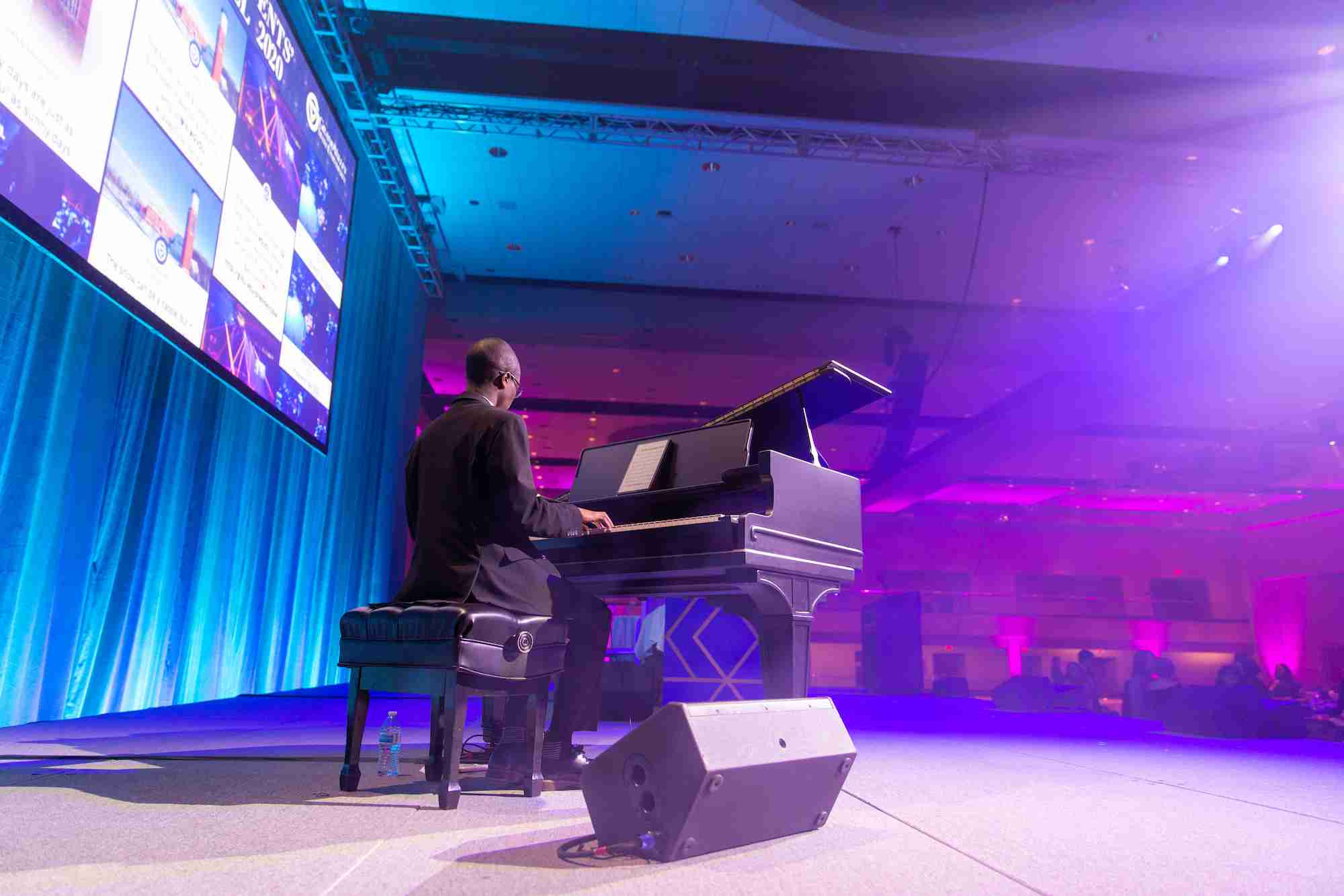 A man playing a piano at Pres Ball