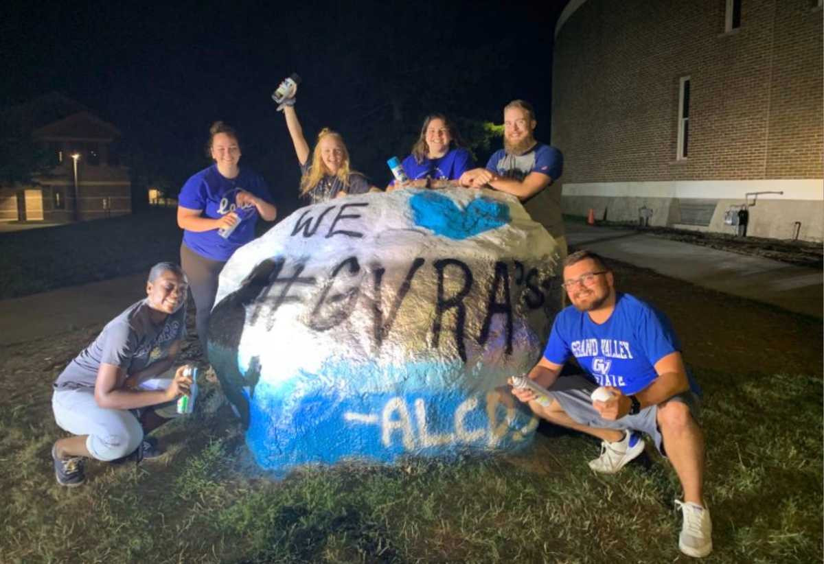 GV RA's painting the rock on the Allendale campus that reads we love #GVRA's