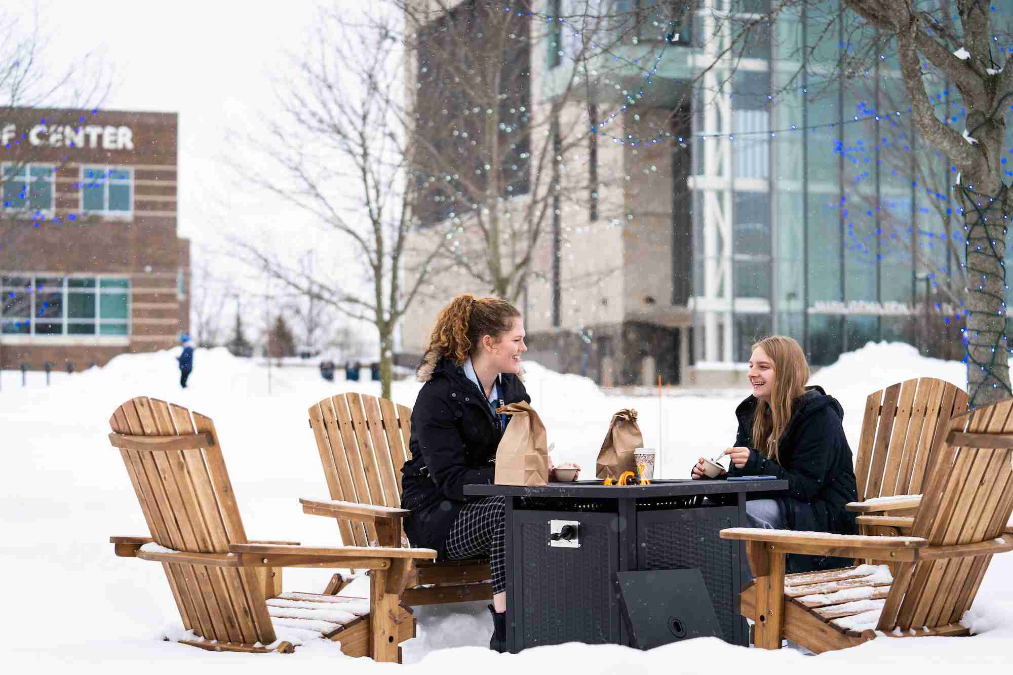 students eating lunch by the firepits outside on Allendale campus