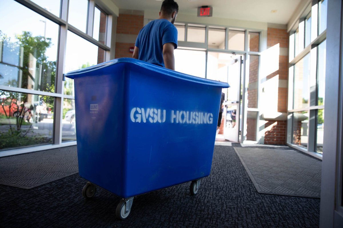 Student rolling a GVSU Housing cart