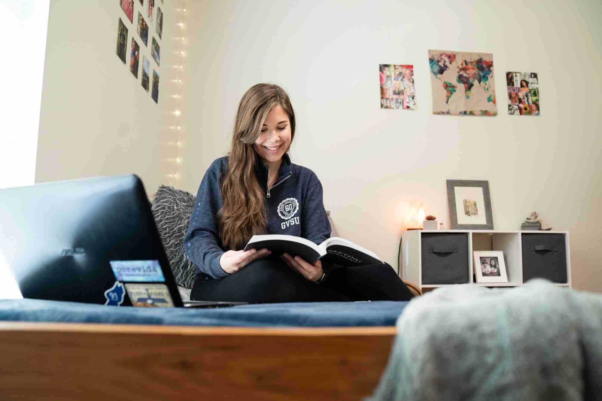 Student reading on bed