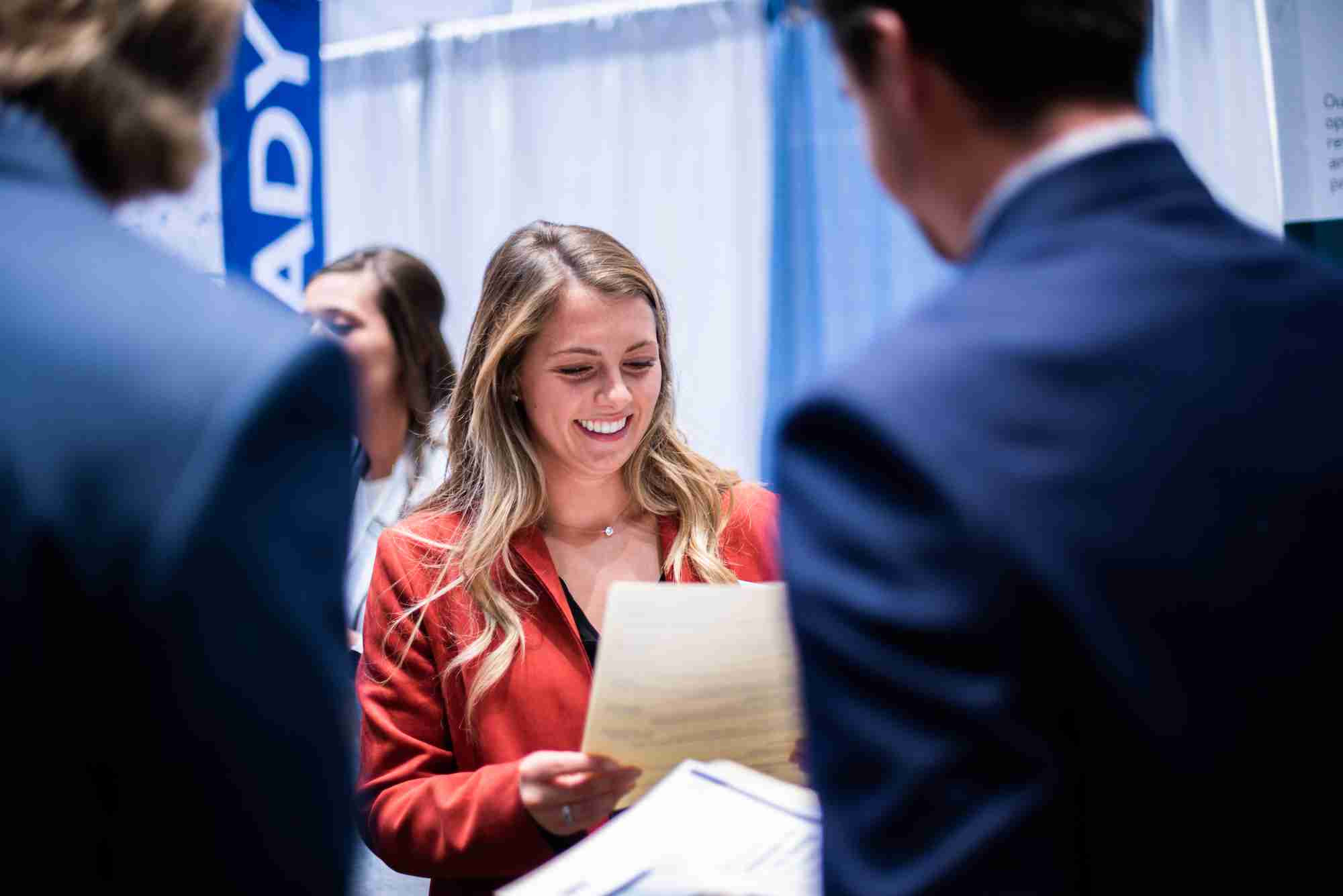 A student smiling at their resume