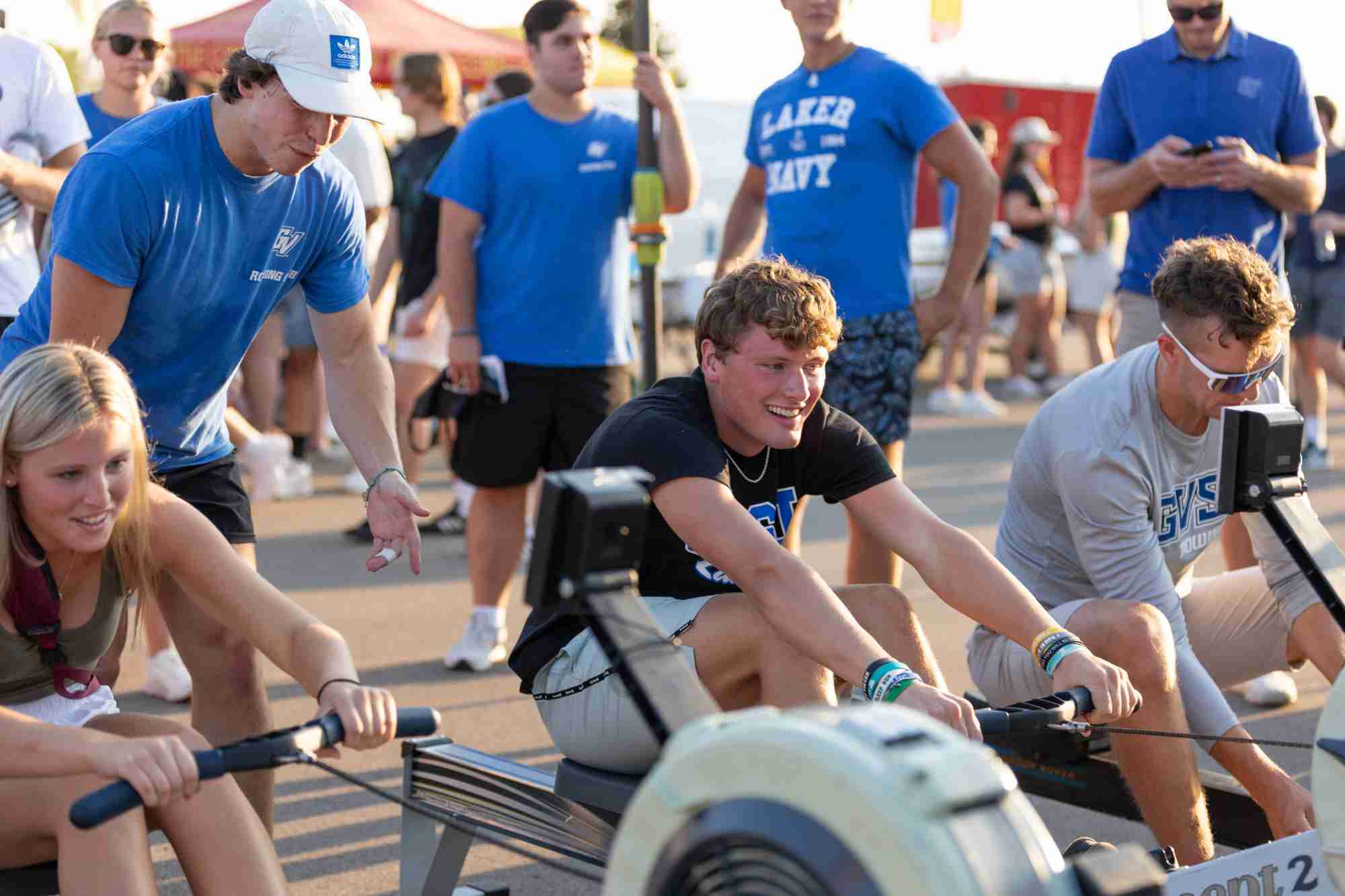 Students trying out rowing machines at Campus Life Night