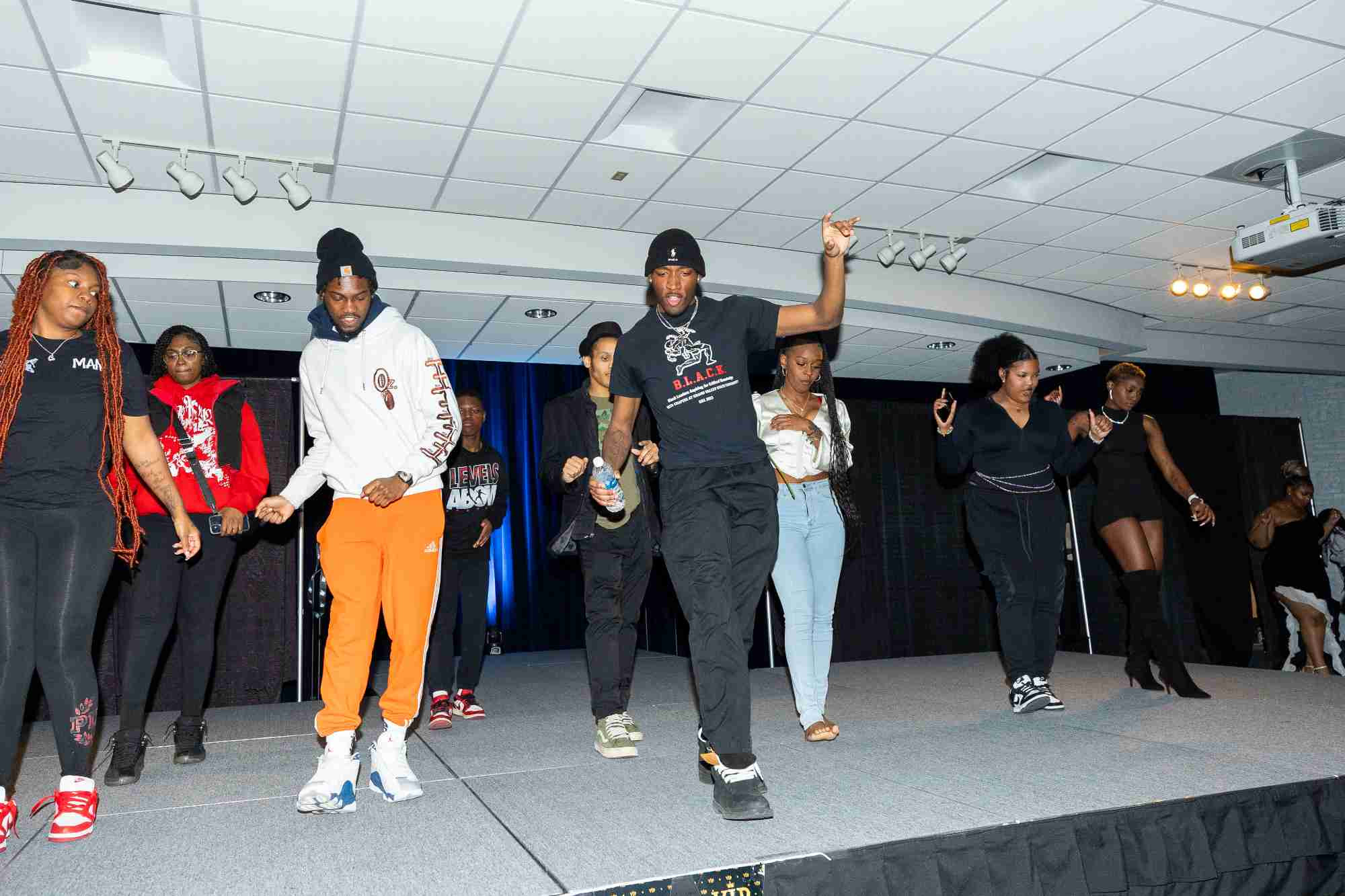 A group of Model Entertainment students dancing onstage