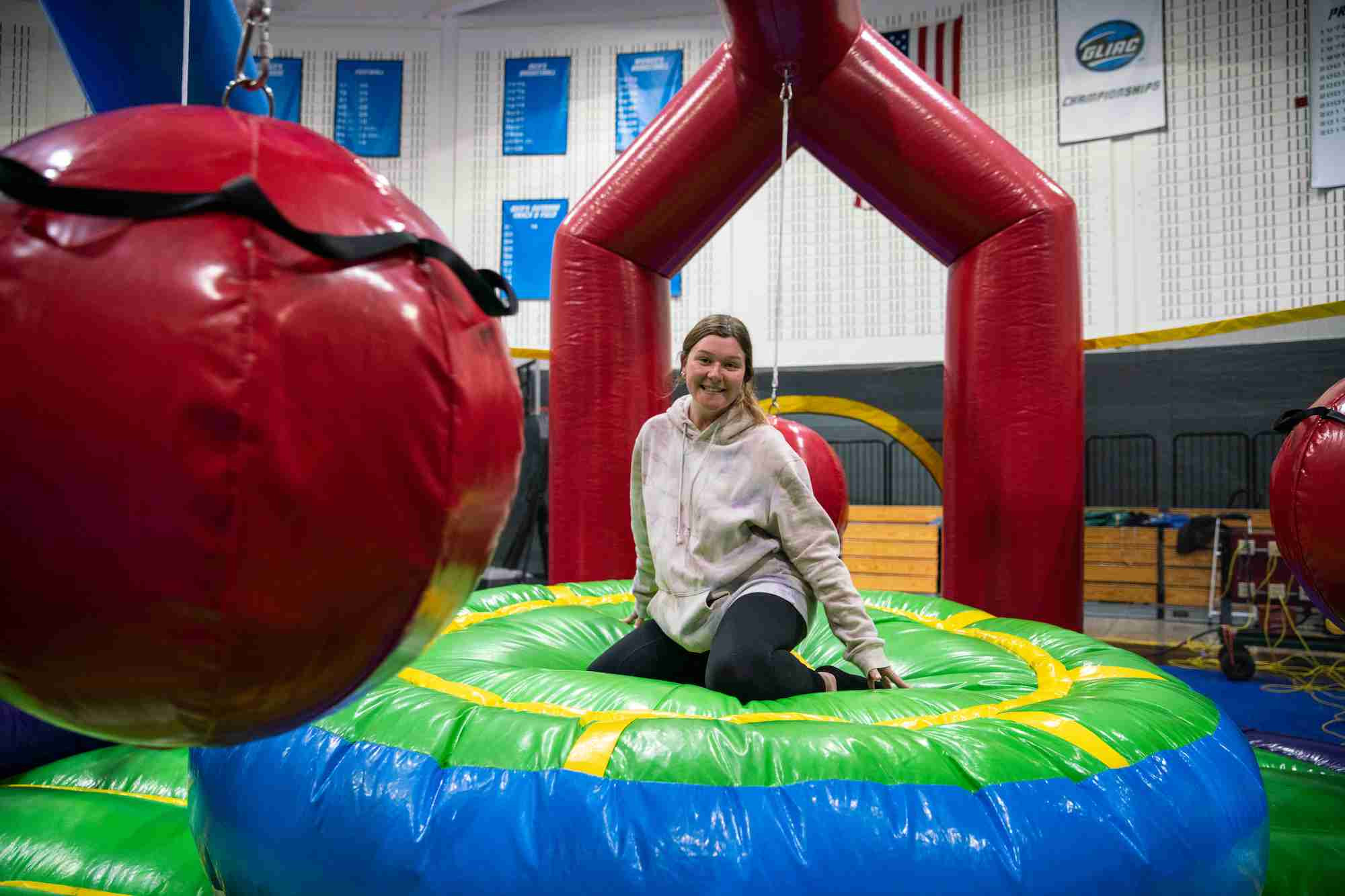 Student smiling at the camera while going through an obstacle course