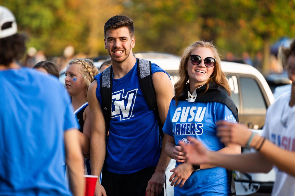 Two college students smiling at a tailgate