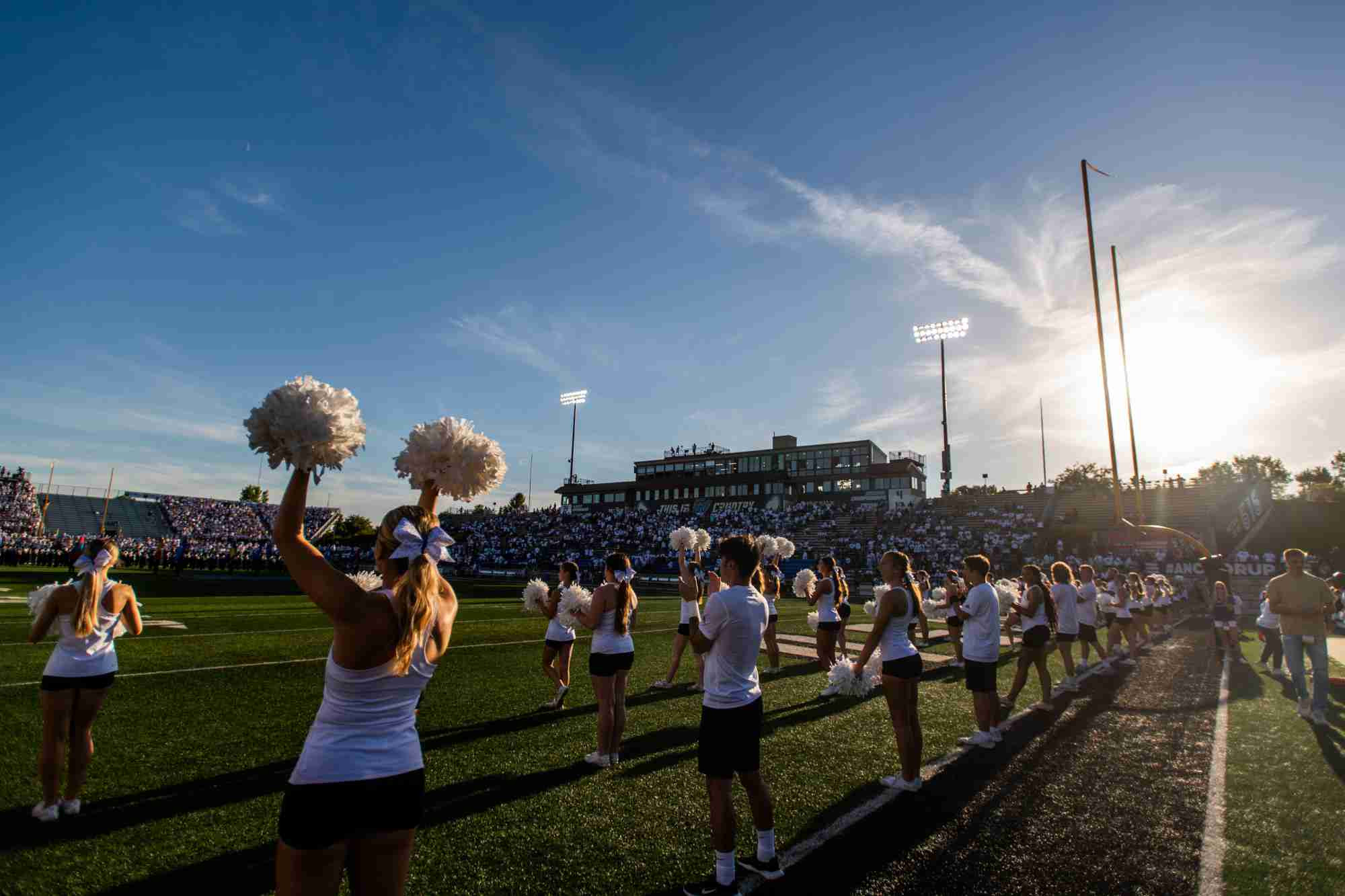 Cheerleaders on the side of the football field 