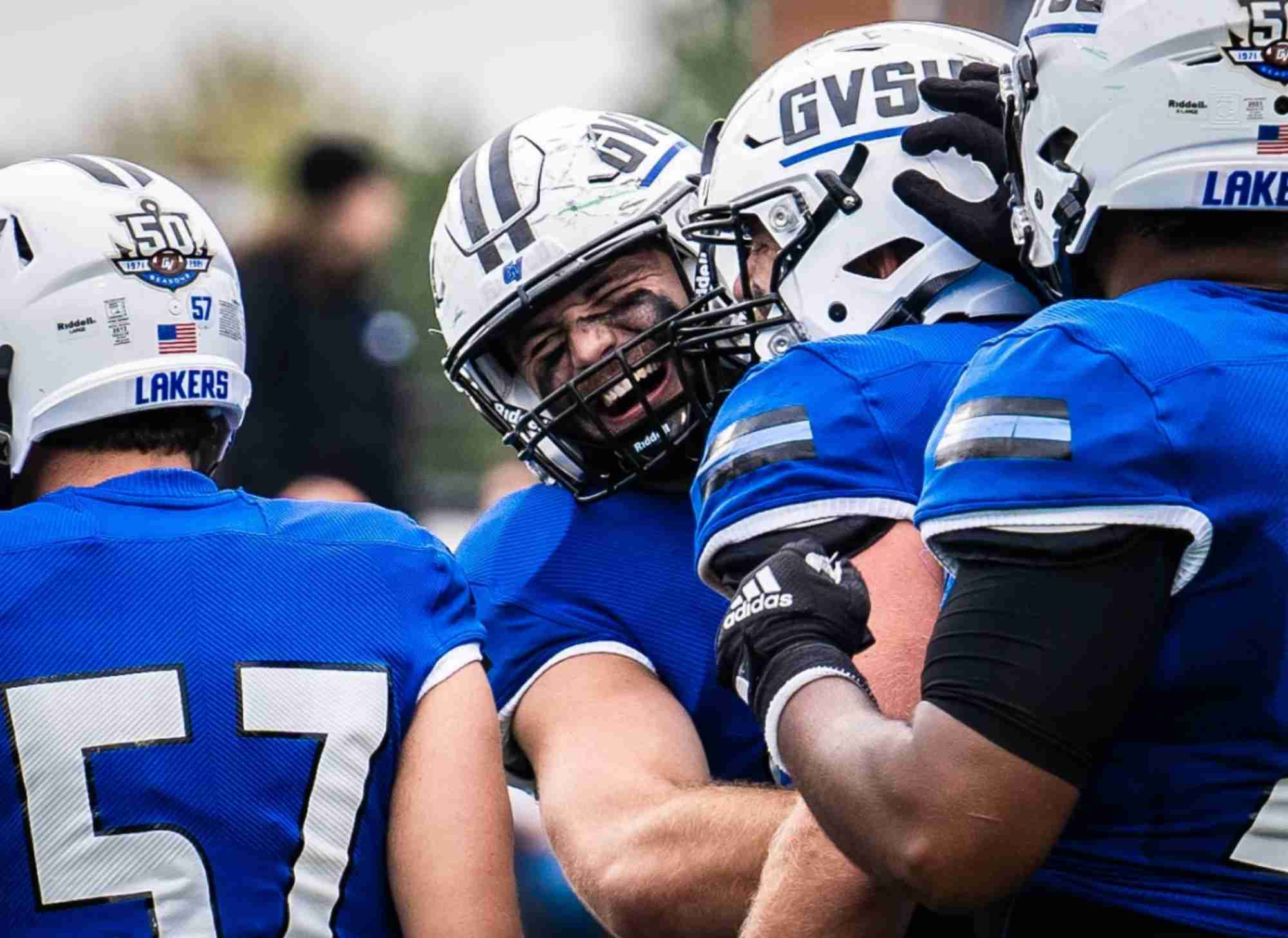 Football Players laughing and hugging