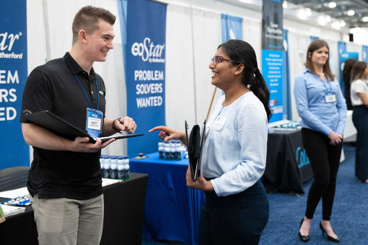 Business professional and student smiling and talking