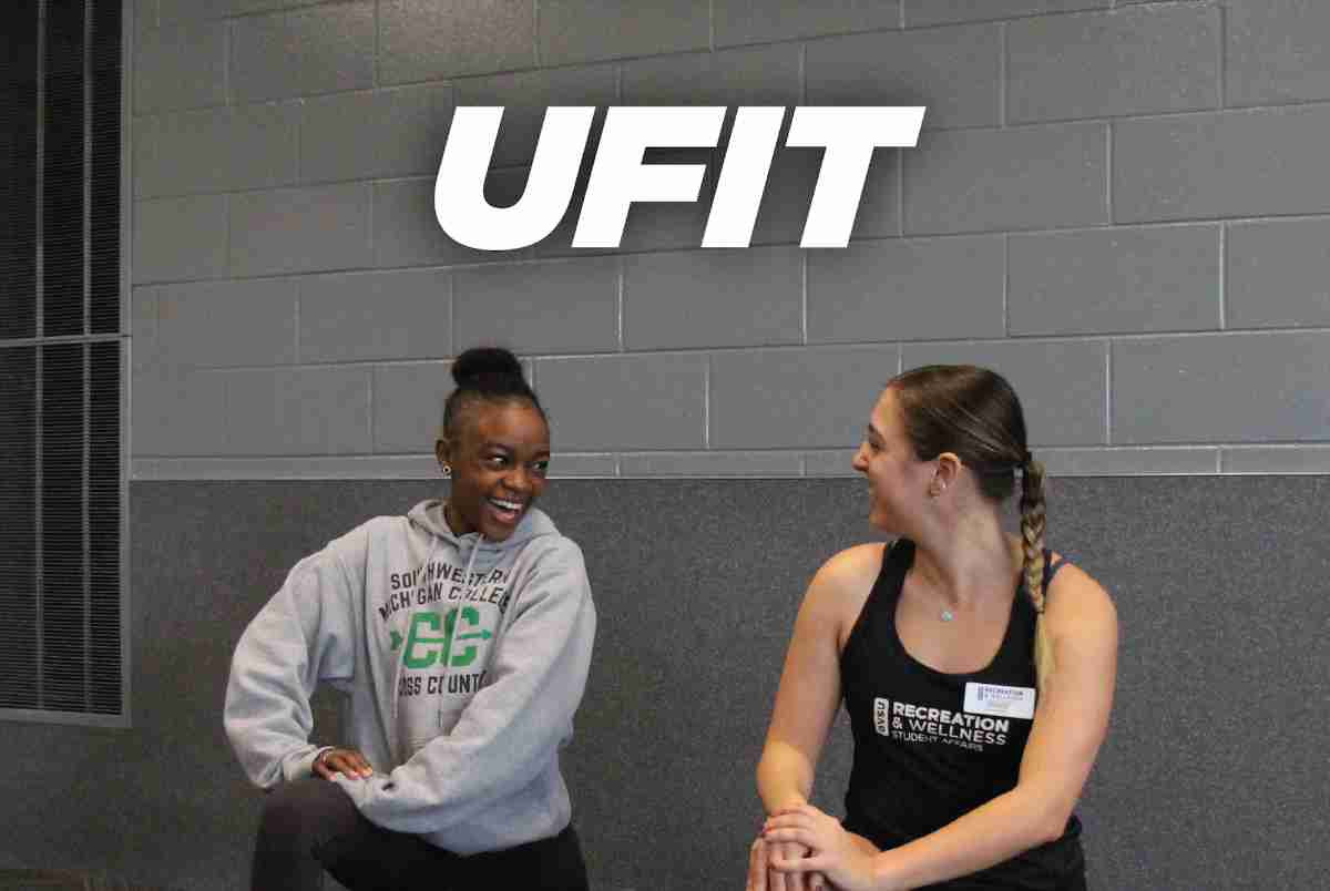 Two students stretching in the REC center with the header "UFIT"
