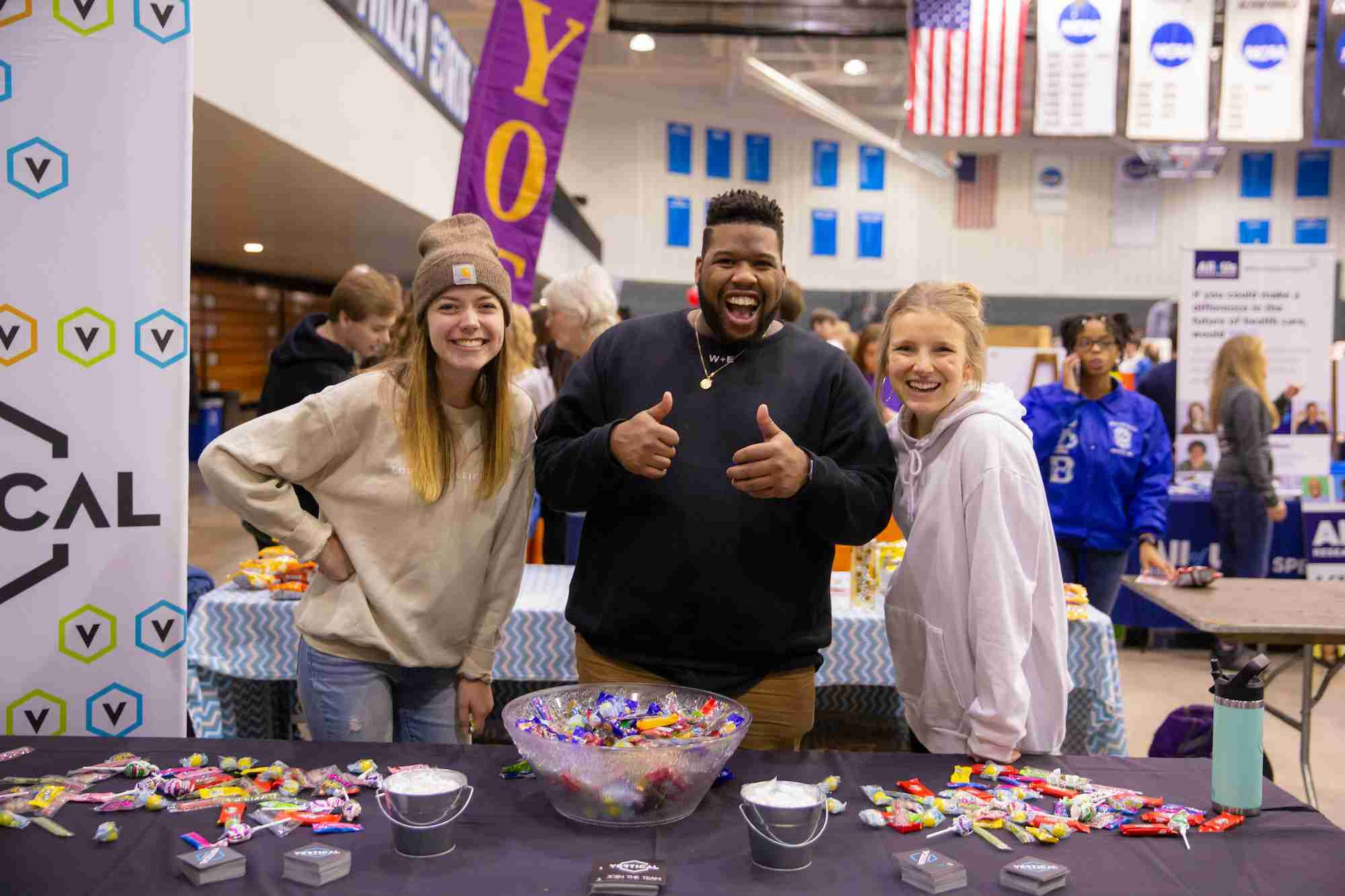 Three students at Campus life night representing a club