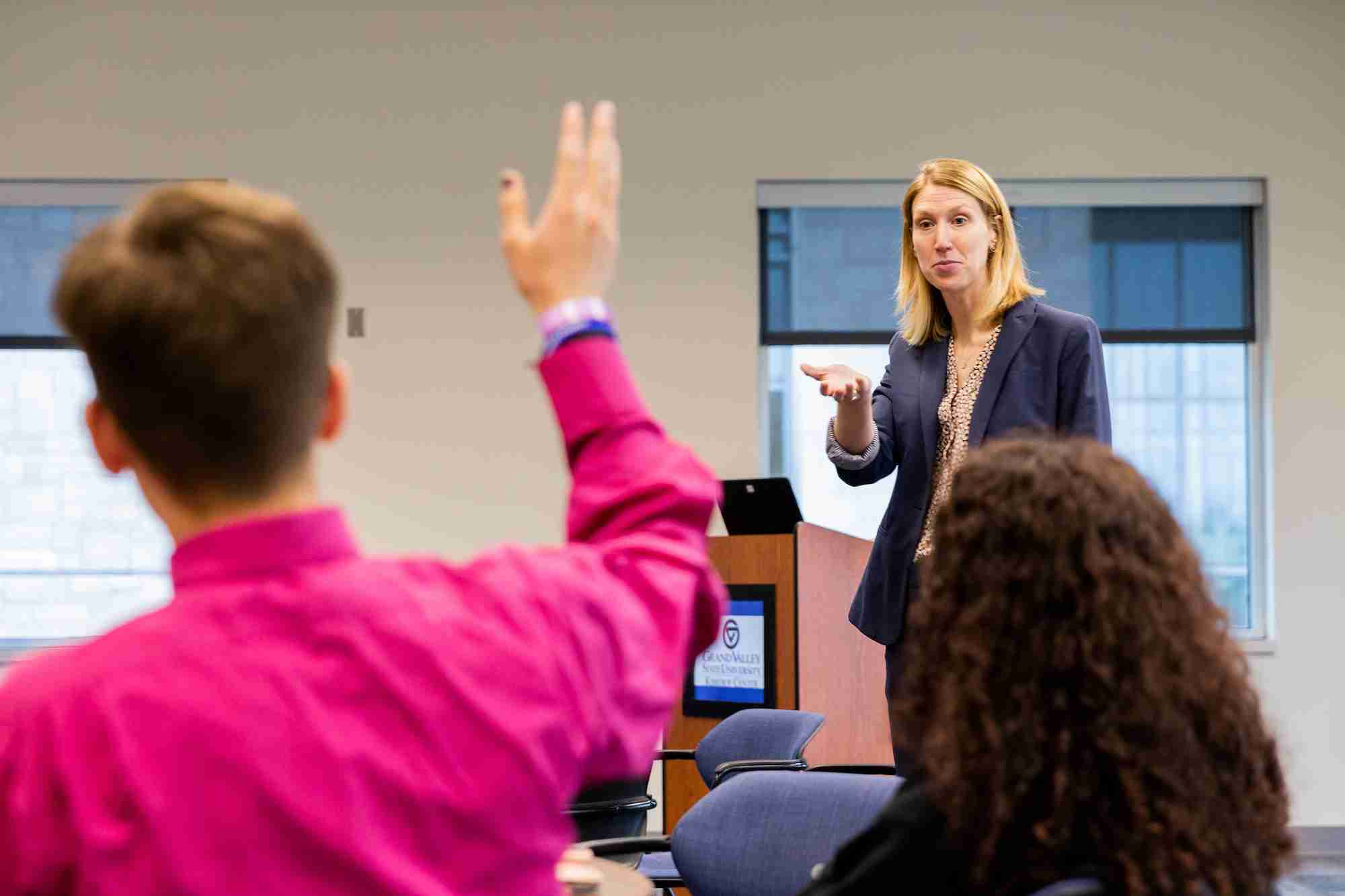 student raising their hand and being called on