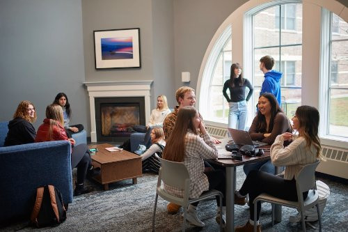 group of students sitting and talking in an on campus living center