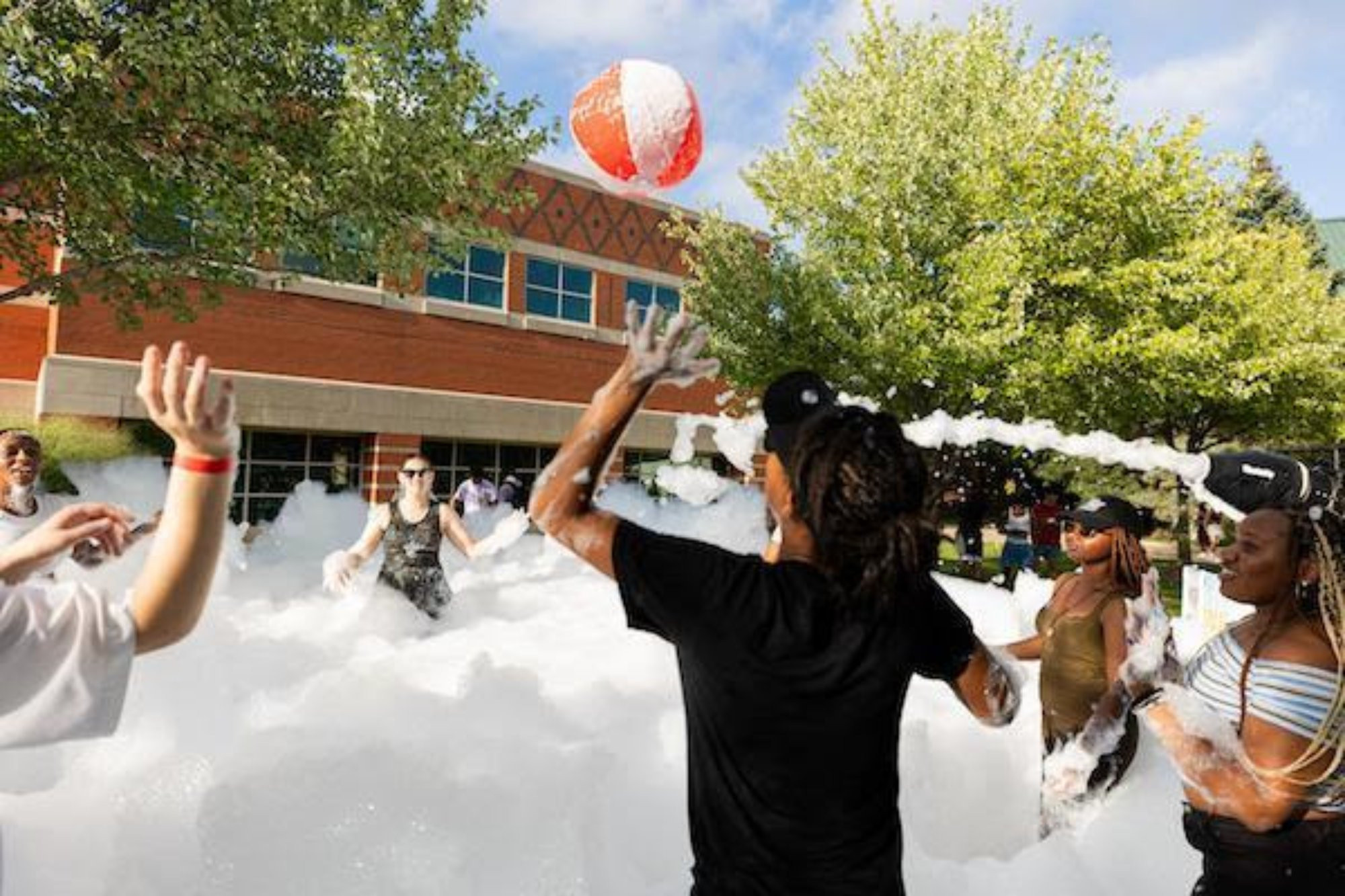 people playing volleyball in a bubble bath