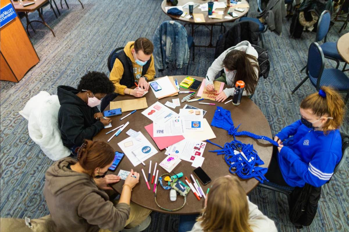 Volunteers working on bags for Kids Food Basket and making dog toys out of T-shirts