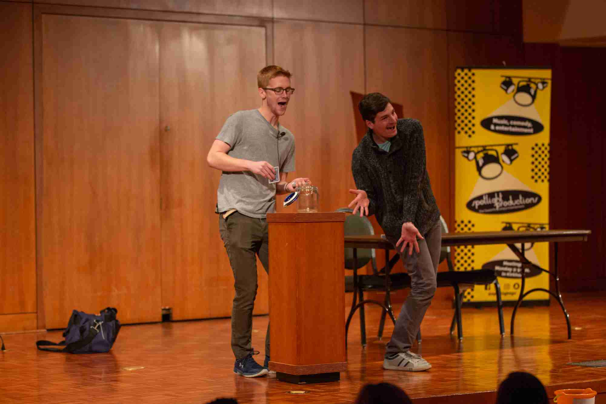 Two student magicians being enthusiastic about their magic trick