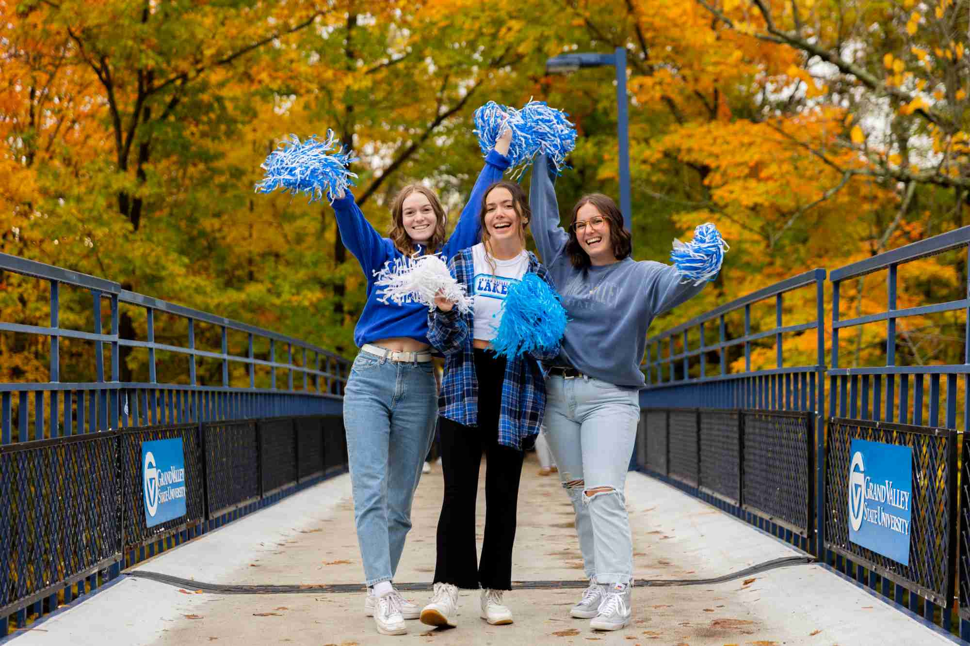 Students with pom poms on blue bridge 